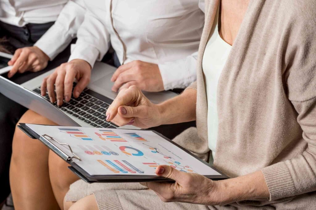 usiness professionals analyzing financial data and charts, representing planning and decision-making for term life insurance policies.