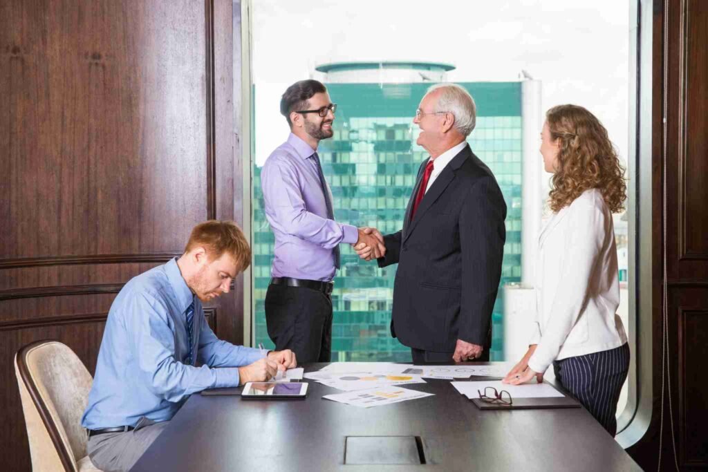 Hands shaking over financial planning documents first time life insurance canada
