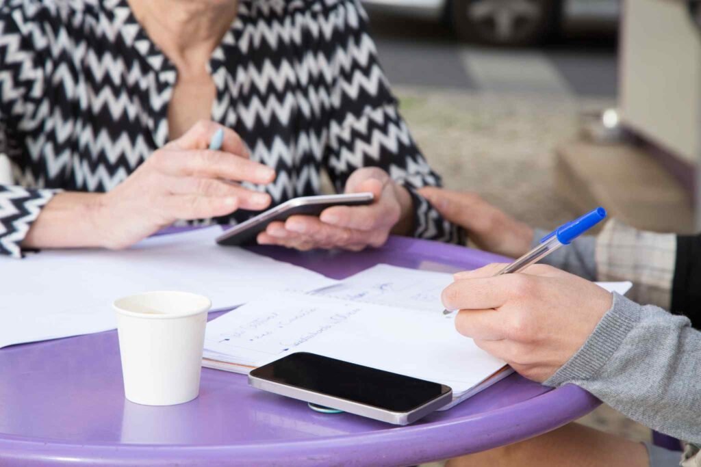 "A hand completing a life insurance application form with a pen, symbolizing taking proactive steps to secure UK lifestyle life insurance for the future."