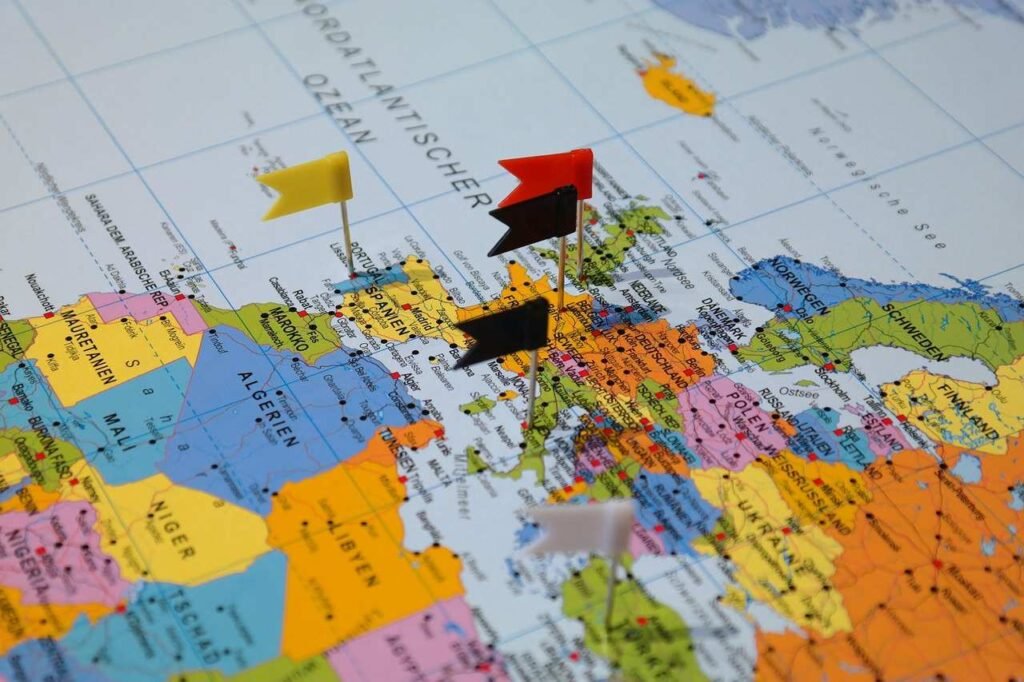 A global map with flag markers, symbolizing global coverage and lifelong protection offered by whole life insurance policies.